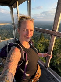 Jess Heck takes a selfie from a firetower in the Adirondacks.