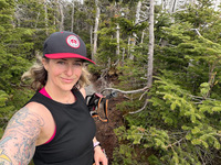 Jess Heck takes a selfie while hiking in the woods.