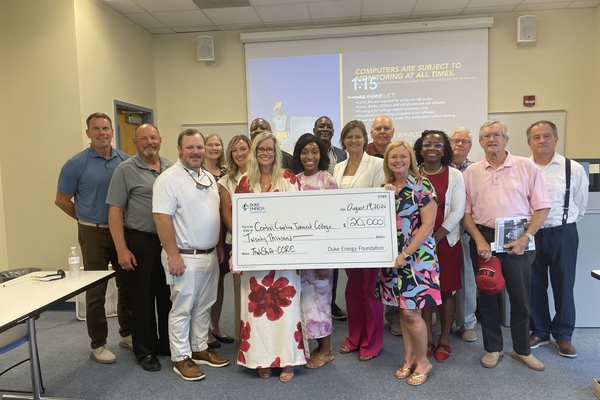 Quinetta Buterbaugh, Duke Energy district manager, Government and Community Relations, presents a check for $20,000 from the Duke Energy Foundation to Dr. Jennifer Wilbanks, CCTC president; Misty Hatfield, vice president for Institutional Advancement and executive director of the CCTC Foundation; and the CCTC Foundation Board of Trustees in support of workforce development through CCTC’s TradeShift-CORE initiative.