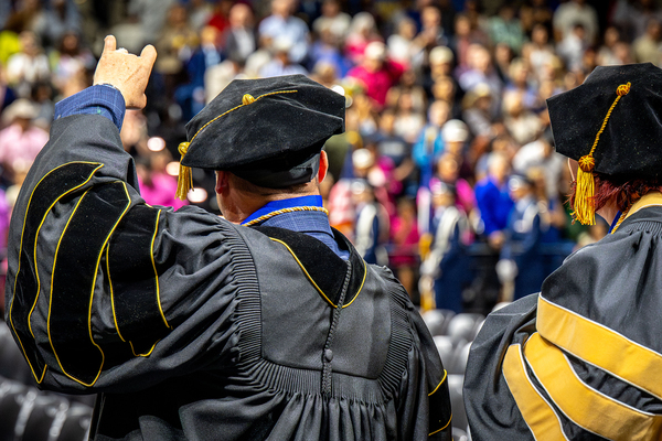 ASU’s first Psy.D. graduates, Drs. Lee Floyd and Kate Vick, acknowledge the audience at spring 2026 commencement