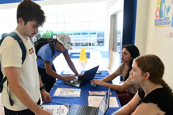 Lindsey Wilson University students Coburn Sandefur ’30 of Beaver Dam, Kentucky, left, and Elijah Lunderman-Hattaway ’30 of St. Marys, Georgia, register to vote on Tuesday, Sept. 15, in the Roberta D. Cranmer Dining & Conference Center lobby as part of National Voter Registration Day. The Lindsey Wilson event was sponsored by the Center for Civic Engagement and Student Leadership. At right are Yayi Sonnabend ’23 Lindsey Wilson Director of Bonner Scholar Program and Civic Engagement and Leadership, center, and Assistant Director of Bonner Scholar Program Jaydelynn Grace Woodall ’27 of Science Hill, Kentucky.