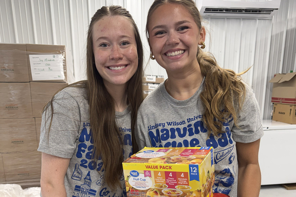 Lindsey Wilson University education freshmen Izz Wyatt of Franklin, Kentnucky, left, and Macey Poindexter of Burkesville, Kentucky, participated in their first Malvina Farkle Day by serving at the food pantry at J.O.Y. Ministries. The university held its annual day of service on Wednesday, Sept. 16.