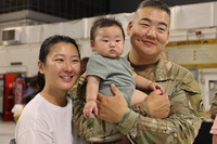 Military family smiling at the camera.