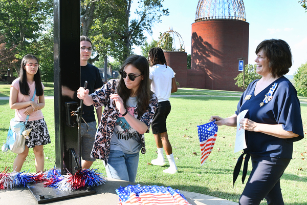 Lindsey Wilson University student Alannah Bowman ’27 of Columbia rings the Alumni Victory Bell on Thursday, Sept. 17, to celebrate Constitution Day. Looking on is Valerie Adams ’90 of the Jane Lampton Chapter of the Daughters of the American Revolution in Columbia. The Daughters of the American Revolution gave every Lindsey Wilson student who rang the Alumni Victory Bell a Constitution swag bag.    