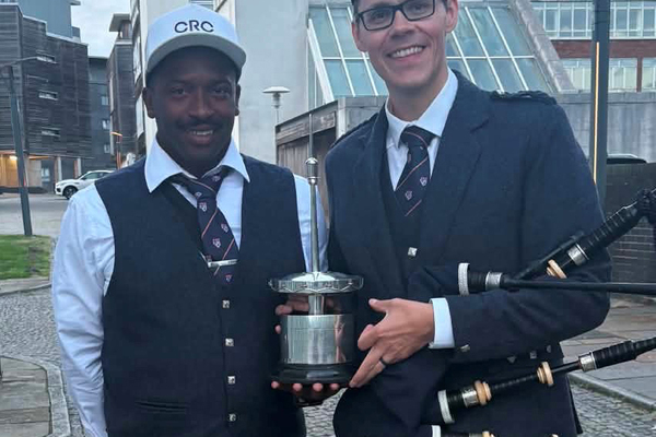 JUBILANT: They never played together as Monmouth students, but now Owen Russell (left) and Zephan Knichel are part of the best pipe band in the world. They're pictured with the RSPBA Jubilee Trophy (a.k.a. “The Spike”) for the Grade 1 world champions.