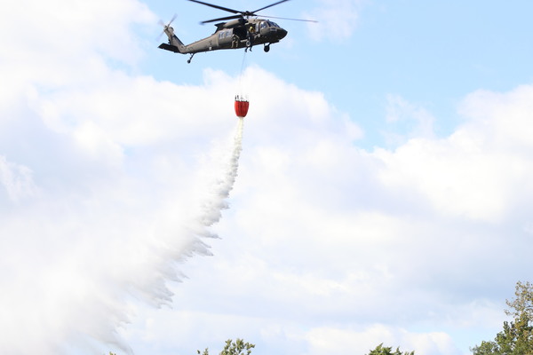 A New York Army National Guard UH-60M Black Hawk dumps water on a target island in the Hudson River south of Schuylerville, New York during water bucket training on Sept. 18, 2026. Aircrews operating out of Army Aviation Support Facility #3 at Albany International Airport in Latham, conducted refresher training on employing 560-gallon Bambi Buckets in aerial firefighting alongside New York State Department of Environmental Conservation Forest Rangers. (U.S. Army photo by Lt. Col. Jean Marie Kratzer)