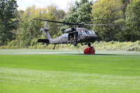 UH-60 lifting off with bucket.