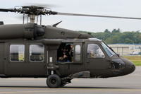 Man waves from window of UH-60.