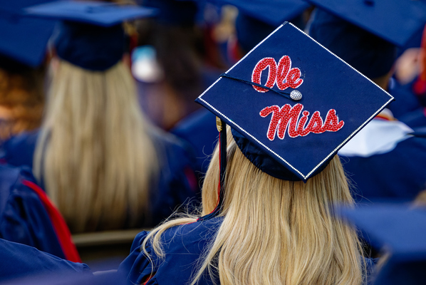 Image of a graduate with a mortarboard decorated with the words 'Ole Miss.' Photo by Hunt Mercier/Ole Miss Digital Imaging Services
