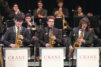 The Crane Jazz Ensemble performs. The saxophone section has Crane School of Music band stands.