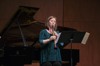 Julianne Kirk Doyle plays the clarinet onstage.