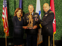 Soldier holds Minute Man award