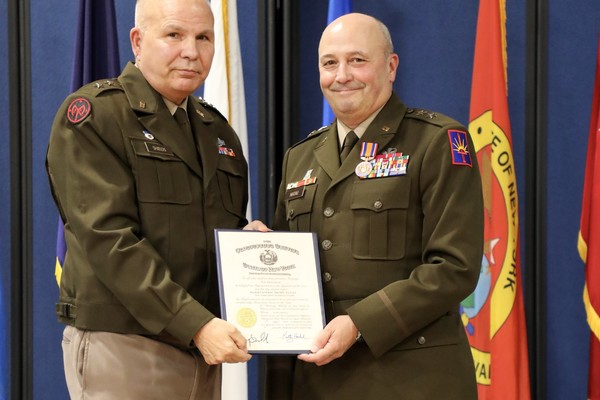 New York Army National Guard Major General Michel Natali, right, accepts the New York State Conspicuous Service Medal from Major General Ray Shields, the adjutant general of New York, during Natali's retirement ceremony at New York National Guard headquarters in Latham on October 2, 2026. Natali, the assistant adjutant general, Army, since 2018,  and a Watertown native, is retiring after almost 40 years of service. (U.S. Army National Guard photo by Stephanie Butler)