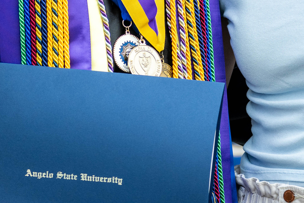 ASU graduate wearing Alpha Chi medal