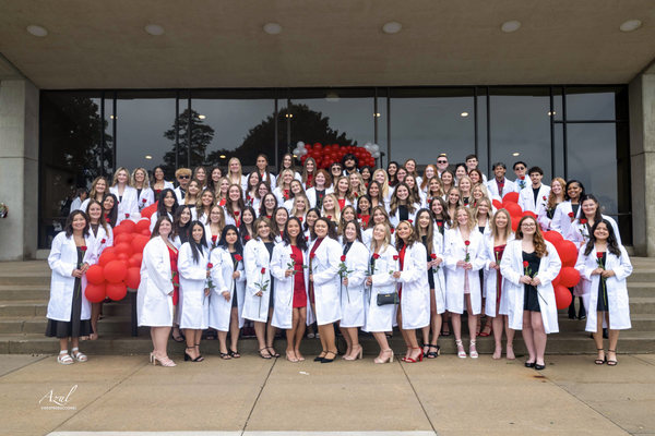Carthage College Nursing Class of 2028 receive white coats as a rite of passage toward becoming a compassionate nurse.
