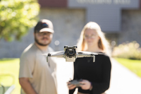 Two SUNY Canton students flying a drone. 
