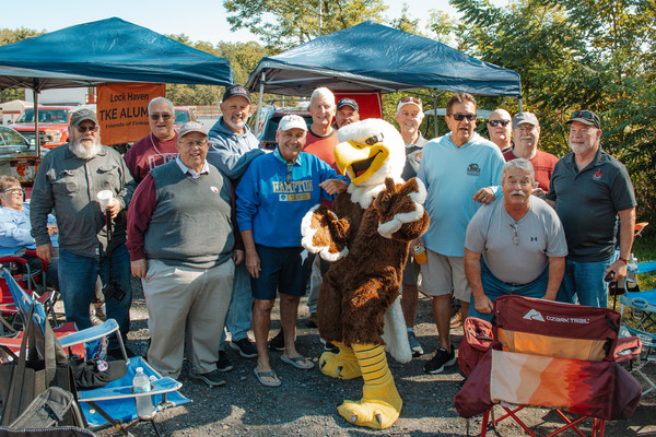 Lock Haven alumni gather with Talon, CU-Lock Haven mascot, at tailgating before the football game.