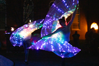 Dancers with glowing wings twirl on the Quad at SUNY Potsdam.