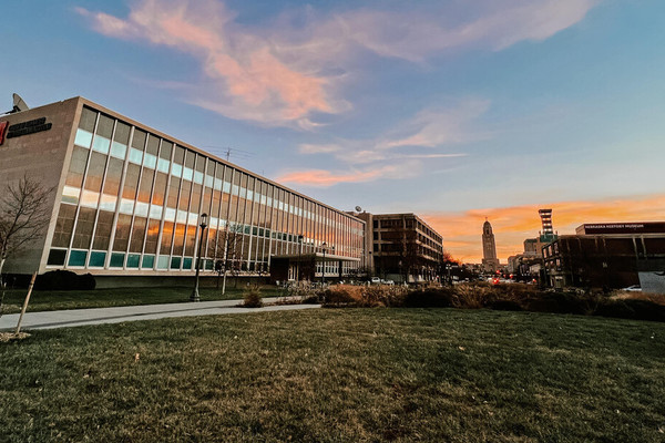 Andersen Hall and the Centennial Mall, with the Nebraska State Capitol in the background, at sunset.