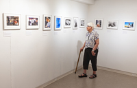 A visitor looks at photos by Stephan Savoia at SUNY Potsdam's Gibson Gallery.