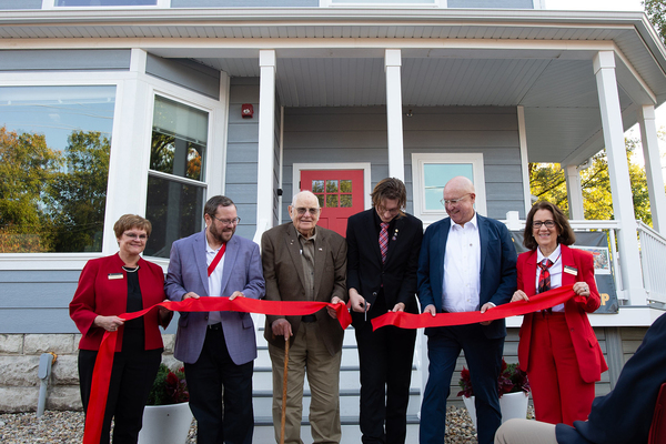 SIGEP HOUSE DEDICATION: Present for the ribbon-cutting were, from left, Dean of Students Karen Ogorzalek, former national president of Sigma Phi Epsilon Brad Nahrstadt '89, founding SigEp initiate Donald "Mac" McKinley '50, chapter president Kent Huth '27, current national president Dave Calderon and Monmouth President Patricia Draves.
