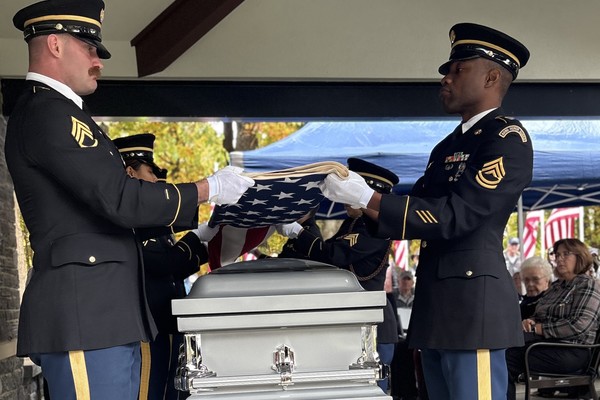 Members of the New York Army National Guard Honor Guard fold an American flag placed on the casket containing remains of Revolutionary War Soldier, during a military funeral for those unknown Soldiers who died at the 1776 Battle of Valcour island during an Oct. 13, 2026 ceremony at Gerald BH Solomon Saratoga National Cemetery in Schuylerville, New York. The Soldiers died during the Battle of Valcour Island on October 11, 1776, which was fought against a British fleet on the waters of Lake Champlain. (U.S. Army National Guard photo by Lt. Col. Jean Marie Kratzer)