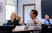 Alysia Eason speaks at a discussion on campus. She is wearing a SUNY Potsdam sweatshirt.