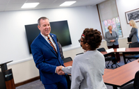 State Assemblyman Scott Gray shakes hands with Alysia Eason ’29.