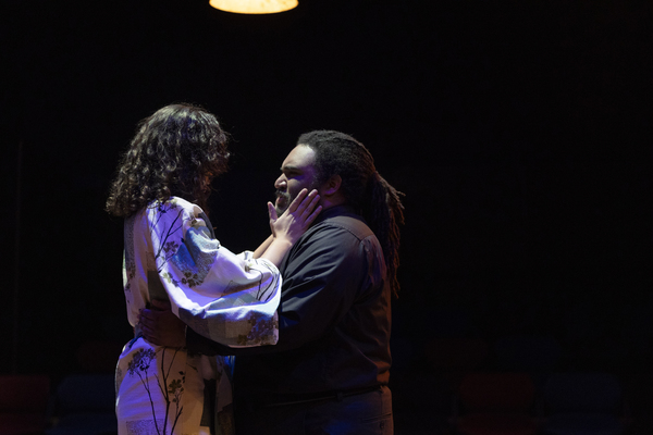 Two college students acting in a theatre production.