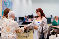 Rose Phillips shakes hands with Dr. Jan Harting McChesney.