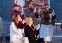 Alumni and supporters applaud during a ribboncutting ceremony.