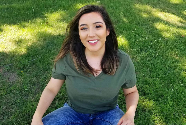 Rae sitting in grass
