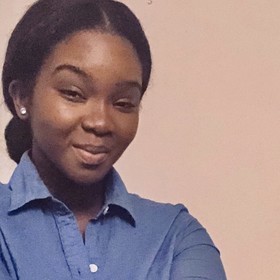 Grace Corally Gbinssey’s headshot.