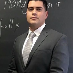 Carlos Bustos De Alvarado’s headshot.