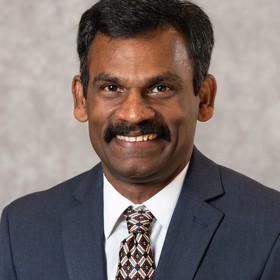 John Peter’s headshot.