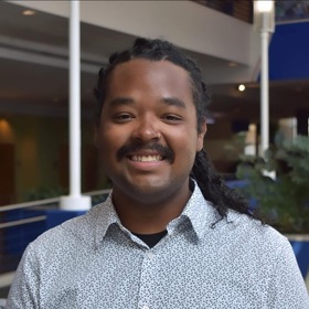 Naj Hughey’s headshot.