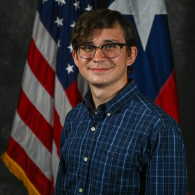 Bruce Homoya III’s headshot.