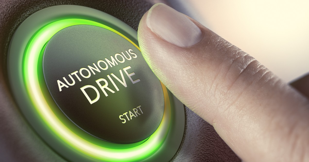 A close view of a finger pressing a glowing, green button that reads 