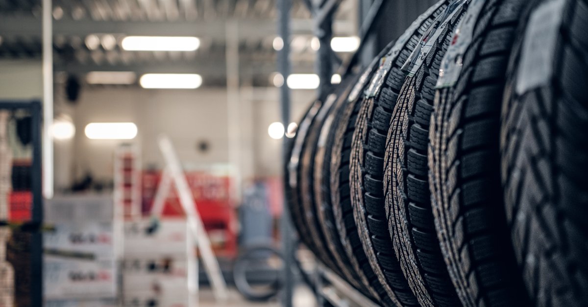 A close-up of tires being stored on a shelf. These tires are brand new and are sitting in an automotive warehouse.