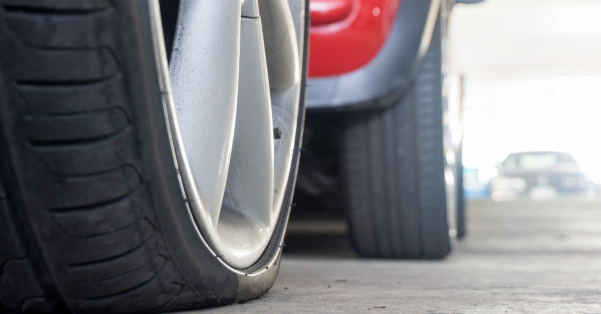 A run-flat tire that is slowly losing air and showing it is deflating. Behind it is a tire that still has air in it.