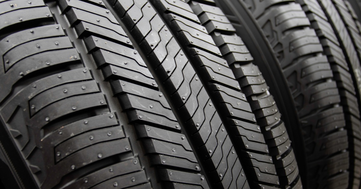 A close-up of a tire with a directional tire tread pattern next to a tire with a similar tread pattern.