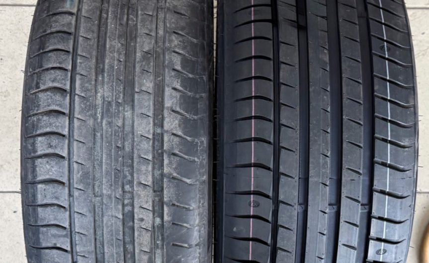 Two tires side by side. The tire on the left is completely worn and used, while the tire on the right is new and clean.