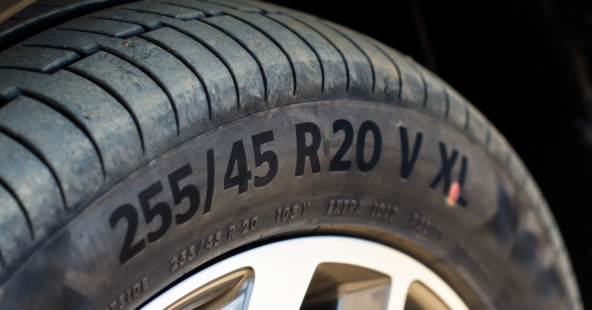 A close-up of a tire's sidewall, slightly worn. The side has the following printed on it: "255/45 R20 V XL."