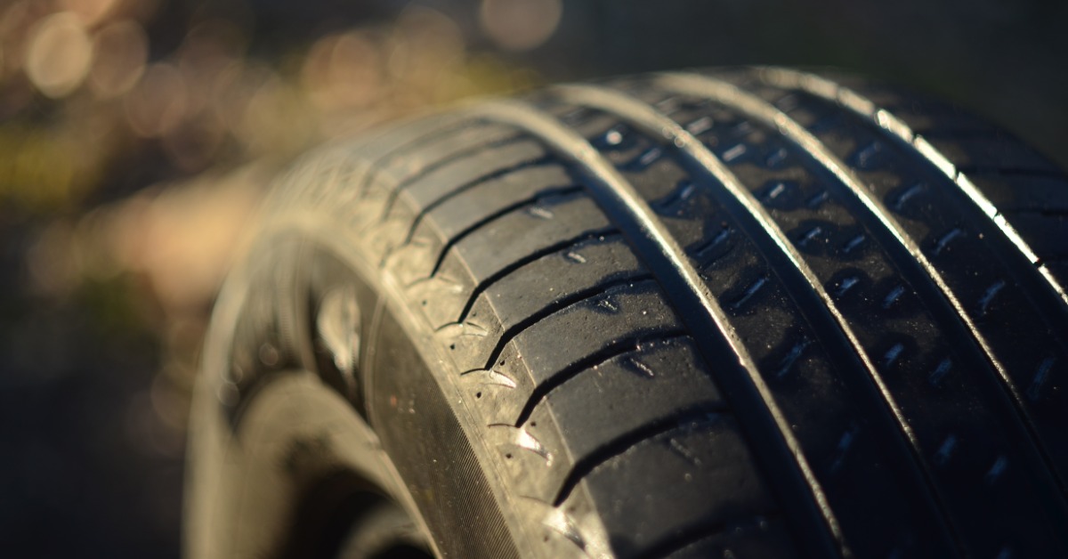 A close-up of the rubber and detailed tread pattern of a new tire. The tire is not yet on a vehicle.