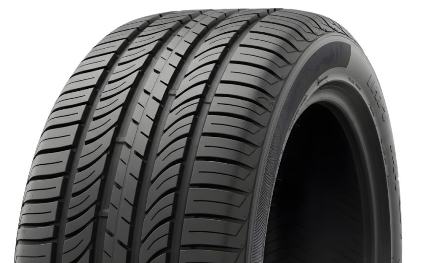 A close-up of the top half of an upright car tire without the wheel against a blank white background.