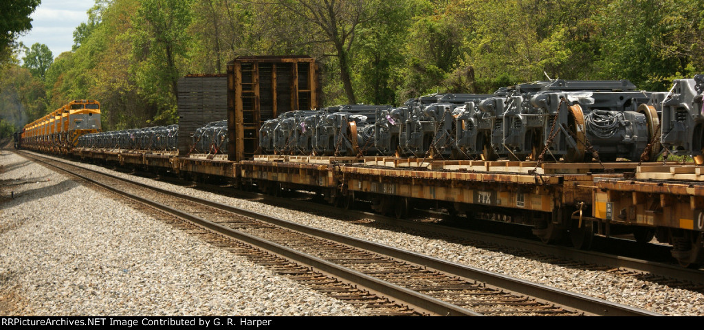 Going-away shot of export locomotives and truck assemblies on NS train R98