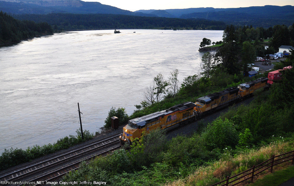 UP stack train heads east through Cascade Locks, OR at sunset