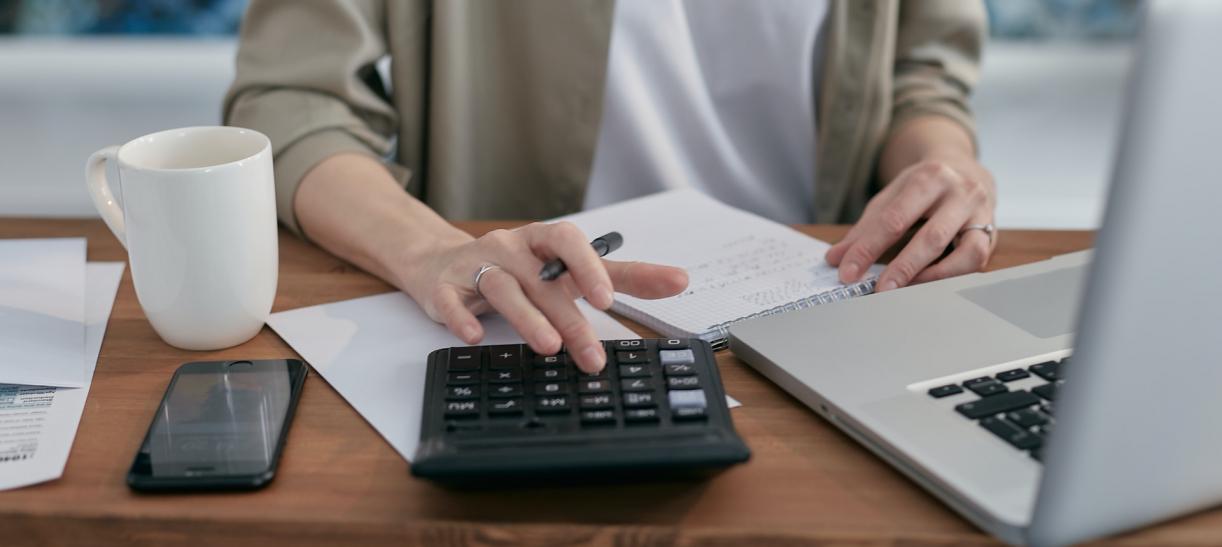 mujer usando calculadora finanzas como evitar deudas