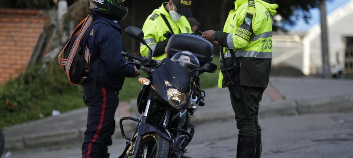 Foto de policías de tránsito junto a motociclista. Ilustra nota sobre desembargo por multas de tránsito.