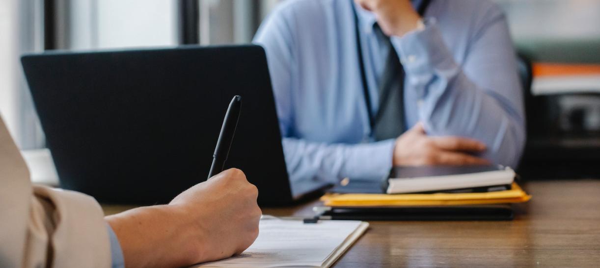 Foto de persona firmando un contrato. Ilustra nota sobre convocatoria de trabajo con el Estado.
